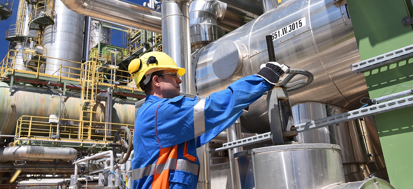 workers in an industrial plant for the production and processing of crude oil